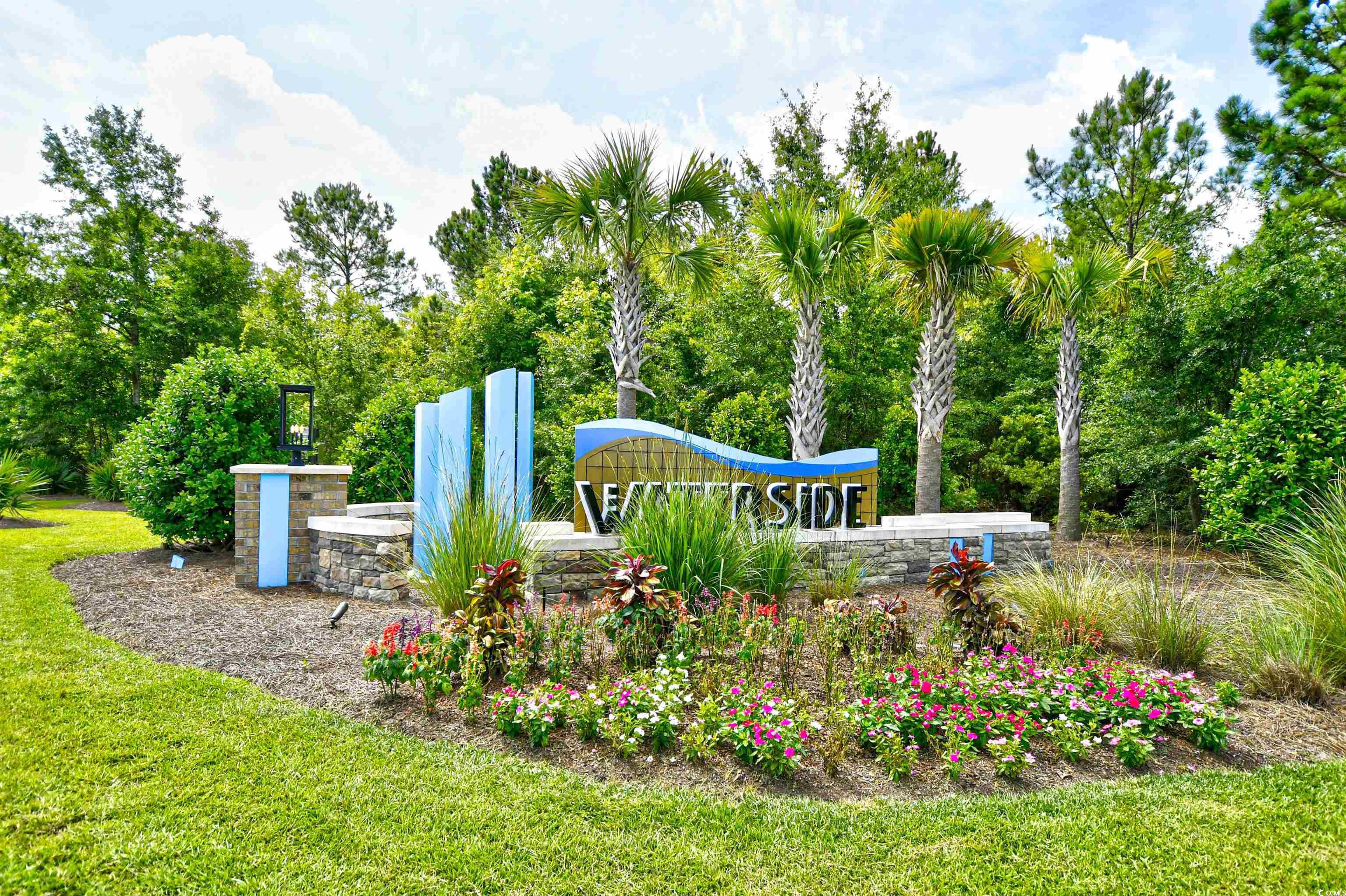 2325 Copper Crk Loop Longs, SC 29568 - Photo 2 of 40 Community sign with a yard and view of wooded area
