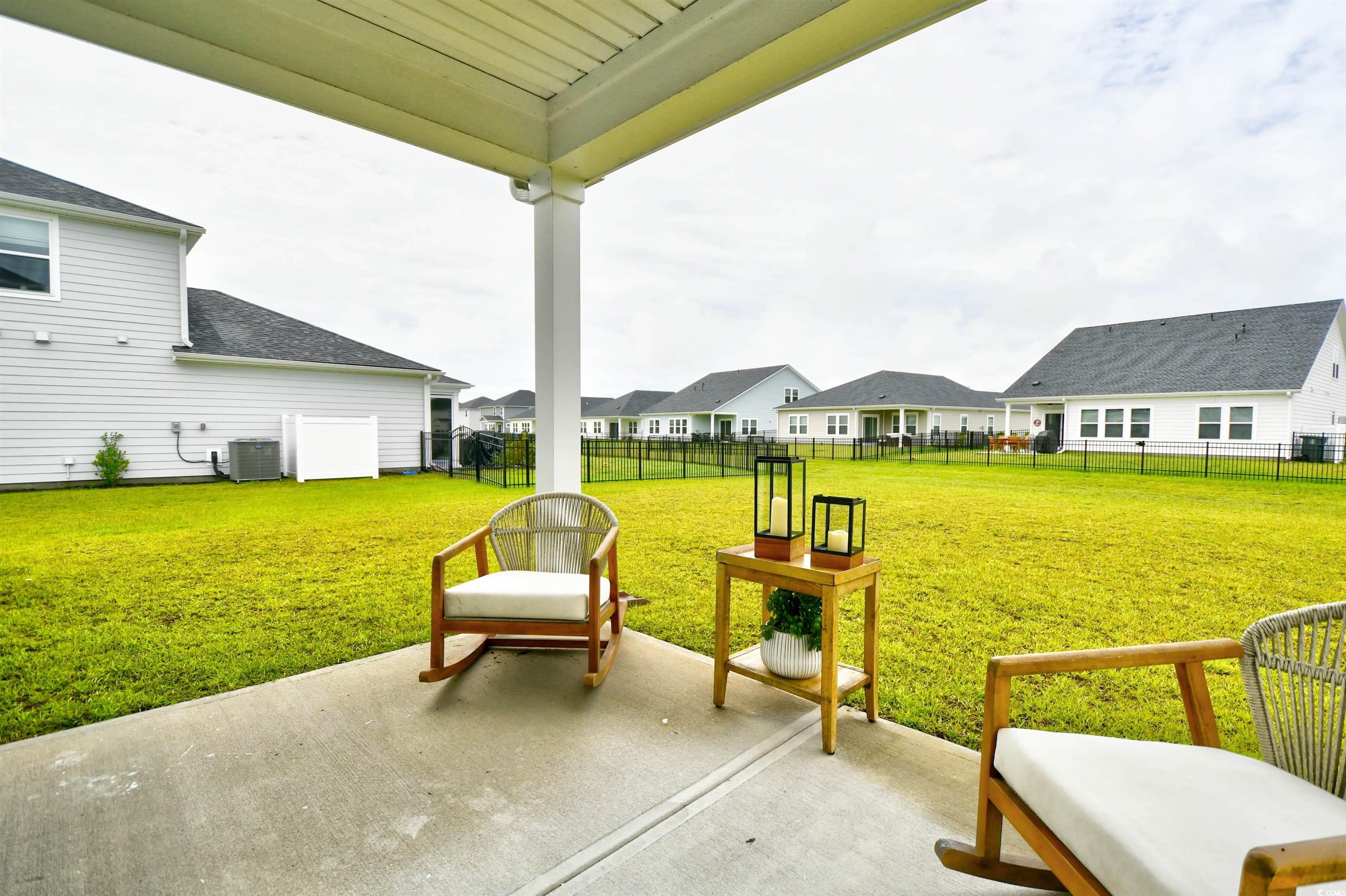 2325 Copper Crk Loop Longs, SC 29568 - Photo 35 of 40 Fenced backyard featuring a patio area and a residential view