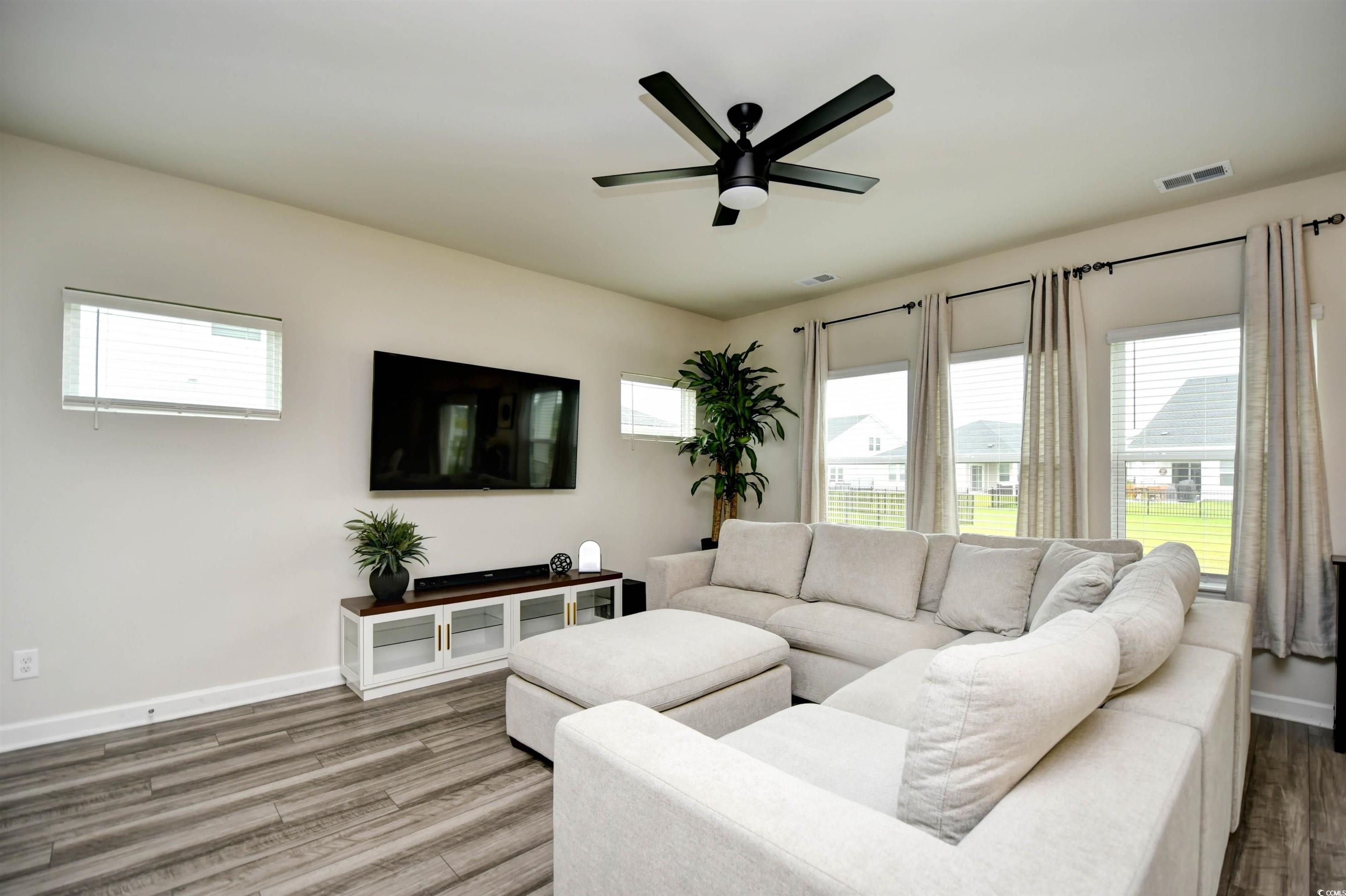 2325 Copper Crk Loop Longs, SC 29568 - Photo 7 of 40 Living room with wood finished floors and ceiling fan