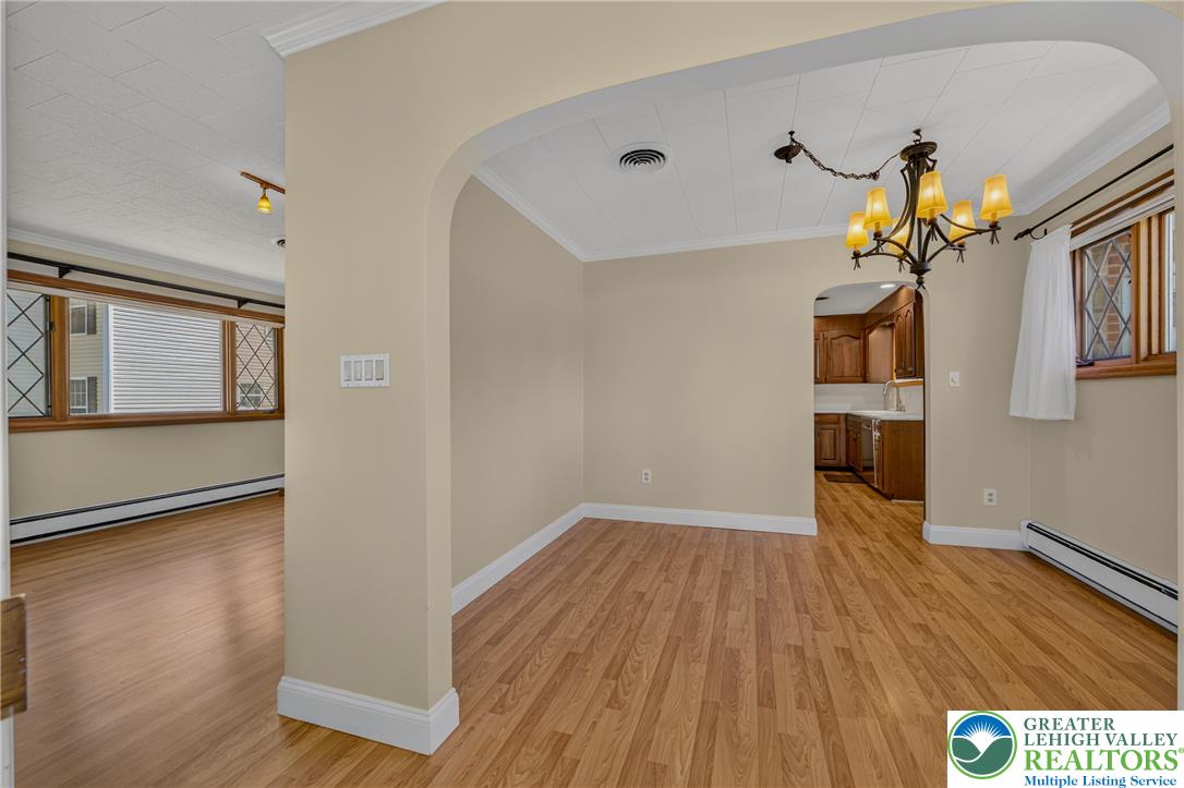1814 Ruth Street Allentown, PA 18104 - Photo 11 of 54 Classic arched doorways seamlessly connect the inviting dining area to adjacent living spaces.