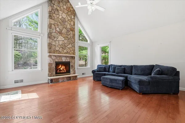 a kitchen with stainless steel appliances granite countertop a stove a sink dishwasher a refrigerator and cabinets with wooden floor