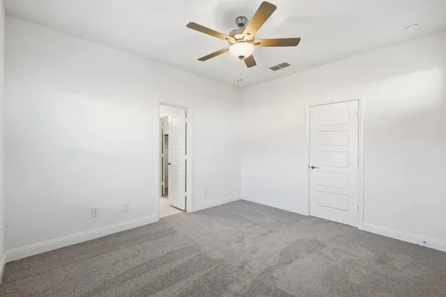 a large kitchen with a center island wooden floor stainless steel appliances and cabinets
