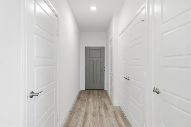 a view of a room with wooden floor