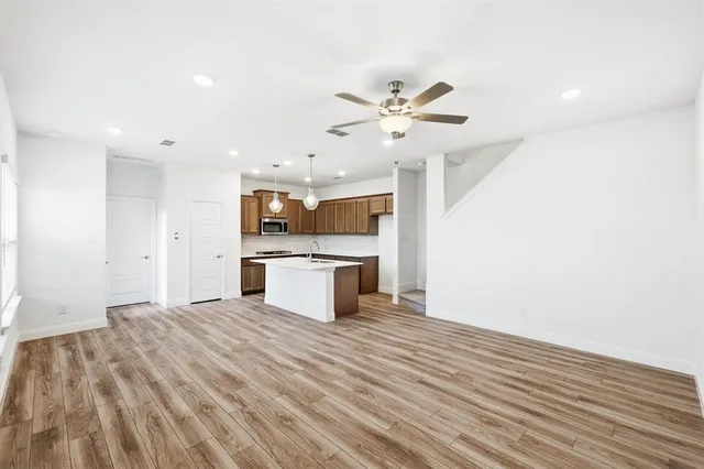 an aerial view of a house with a garden and lake view