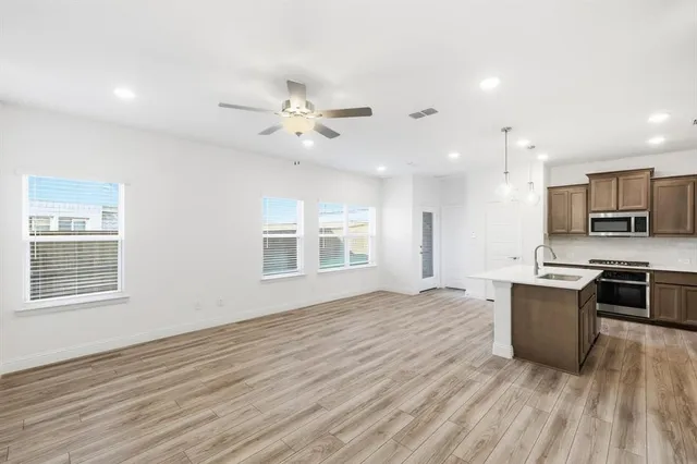 an aerial view of a house with a garden and lake view