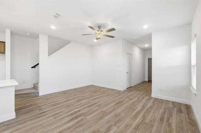 a view of kitchen with granite countertop cabinets stainless steel appliances and a sink