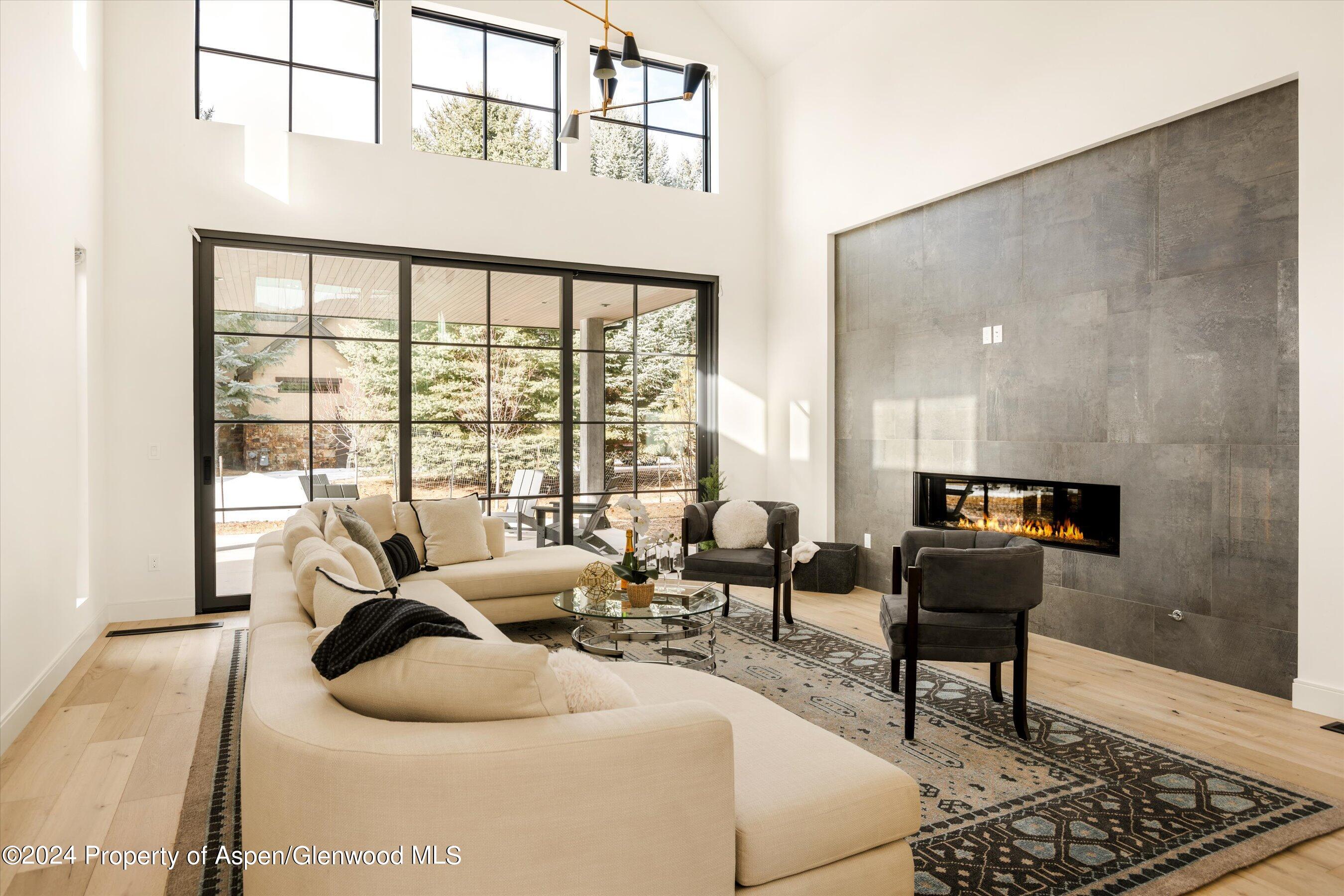 505 Diamond A Ranch Road Carbondale, CO 81623 - Photo 8 of 33 a living room with furniture and a floor to ceiling window