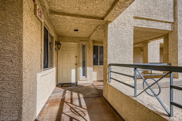 270 East Flamingo Road, Unit 315 Las Vegas, NV 89169 - Photo 2 of 11 Secure building entry features a durable door and decorative metal railing leading to residences.