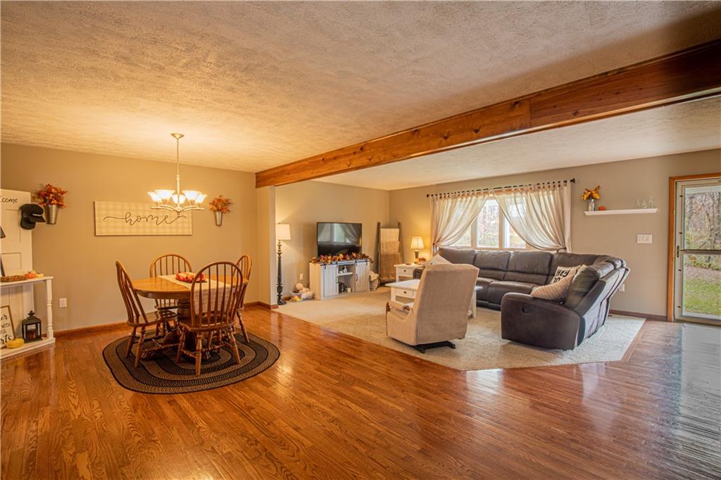 178 Kaider Road Uniontown, PA 15401 - Photo 8 of 17 a living room with furniture a dining table and a chandelier