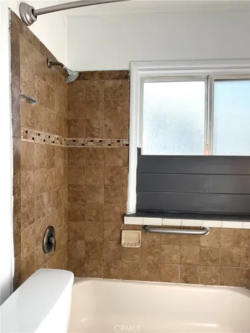 a bathroom with a bathtub and shower