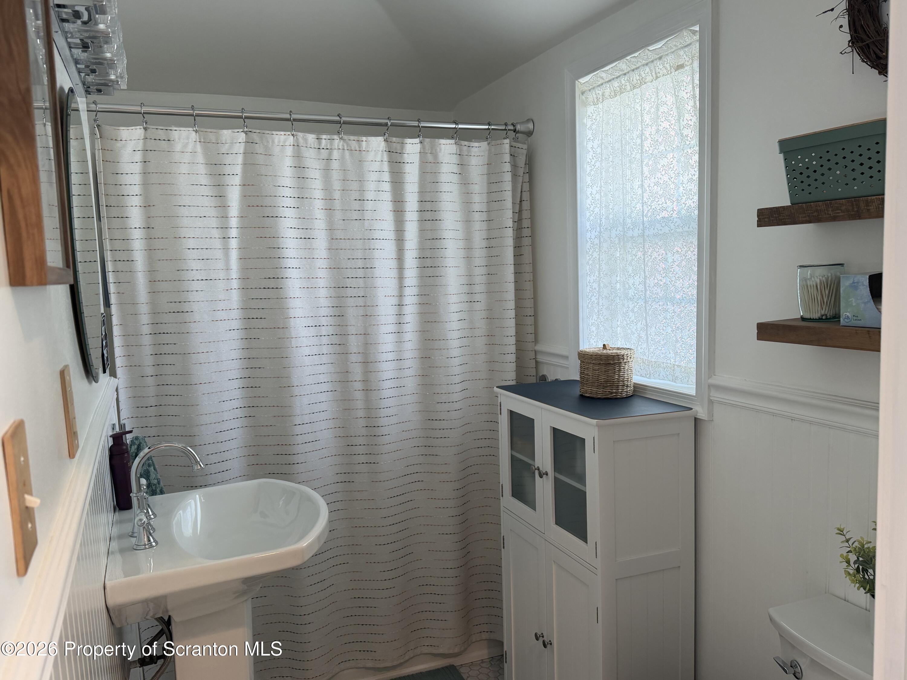320 Haverly Street Throop, PA 18512 - Photo 20 of 27 a bathroom with a granite countertop sink and a mirror