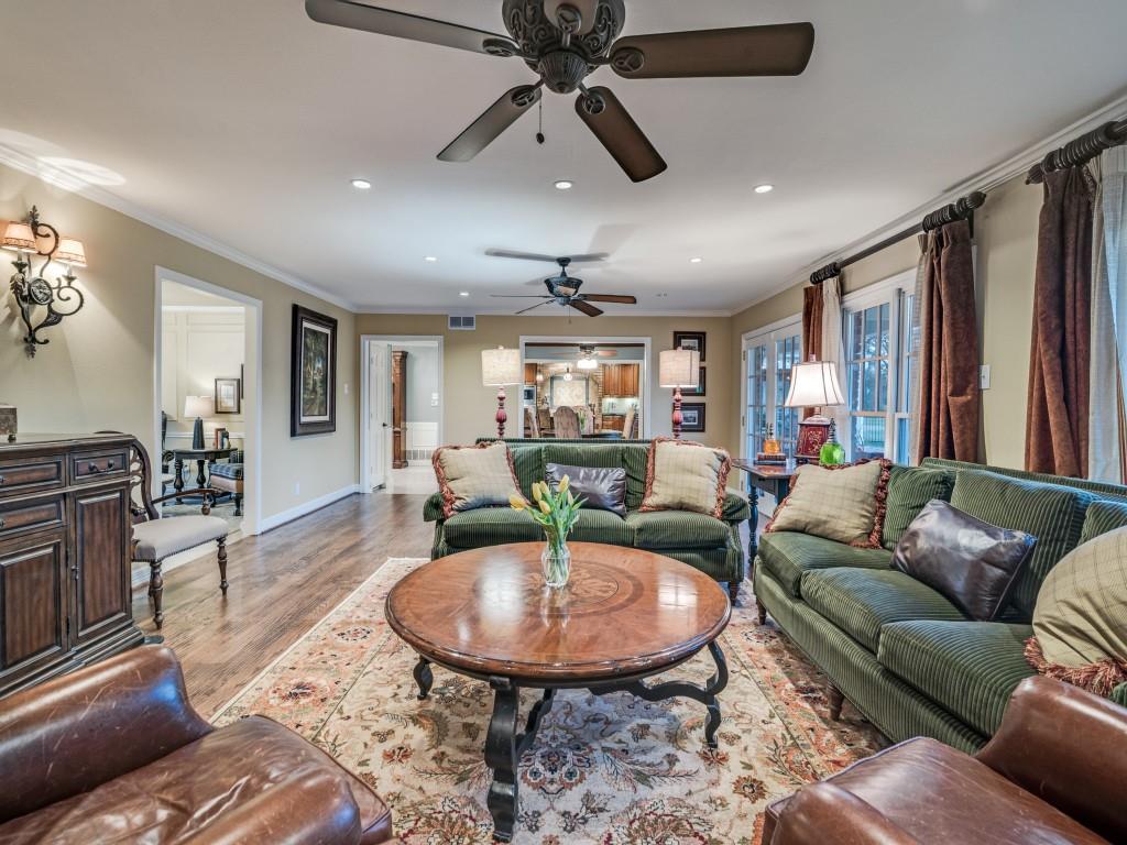 343 East Tripp Road Sunnyvale, TX 75182 - Photo 11 of 36 a living room with furniture a dining table and a chandelier