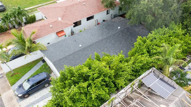 an aerial view of a house with a yard and a garden