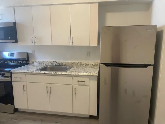 a kitchen with a sink and cabinets