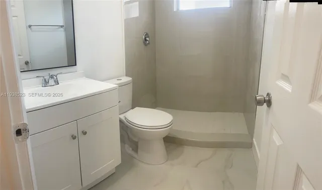 a bathroom with a toilet sink and shower