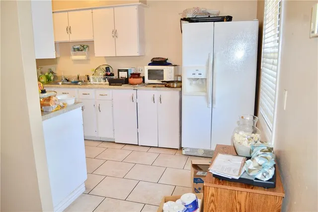 a kitchen with stainless steel appliances a refrigerator and cabinets
