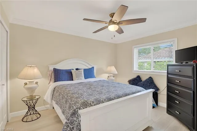 a bedroom with a bed and furniture with window