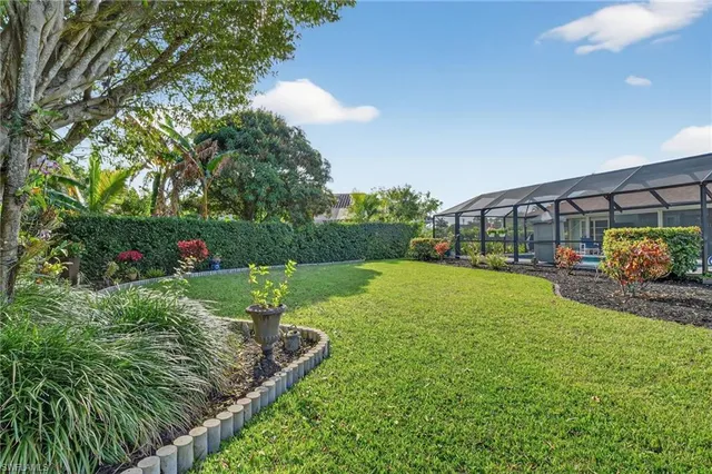 a view of yard with swimming pool and green space