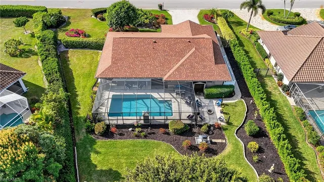 an aerial view of a house with garden space and swimming pool