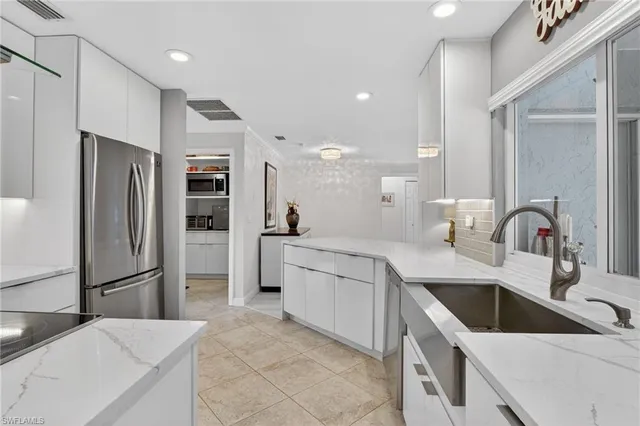 a kitchen with a sink cabinets and refrigerator