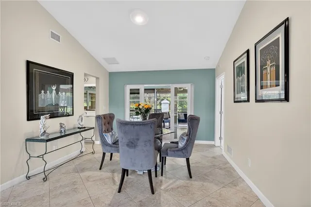 a view of dining room and livingroom with furniture wooden floor and windows