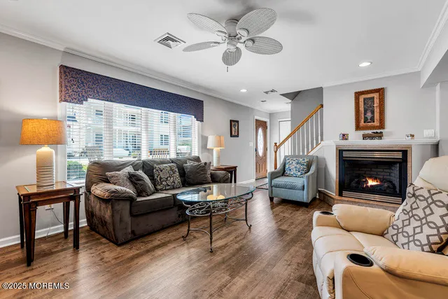 a living room with furniture a fireplace and a flat screen tv