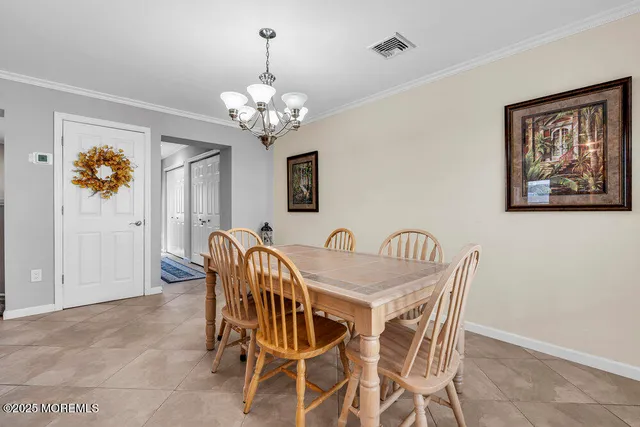 a view of a dining room with furniture and chandelier