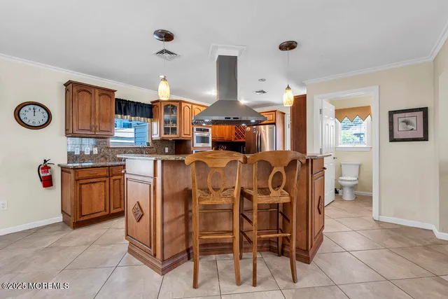 a large kitchen with cabinets and chairs