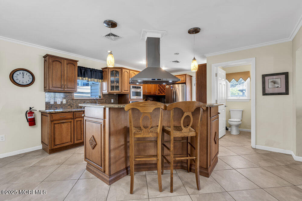 2 A Holiday Road Seaside Heights, NJ 08751 - Photo 15 of 50 a large kitchen with cabinets and chairs