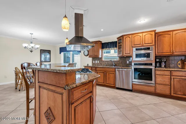 a kitchen with stainless steel appliances granite countertop a stove top oven a sink dishwasher and cabinets
