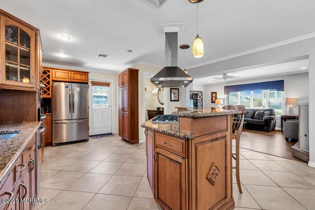 a kitchen with stainless steel appliances granite countertop a sink a stove and a refrigerator