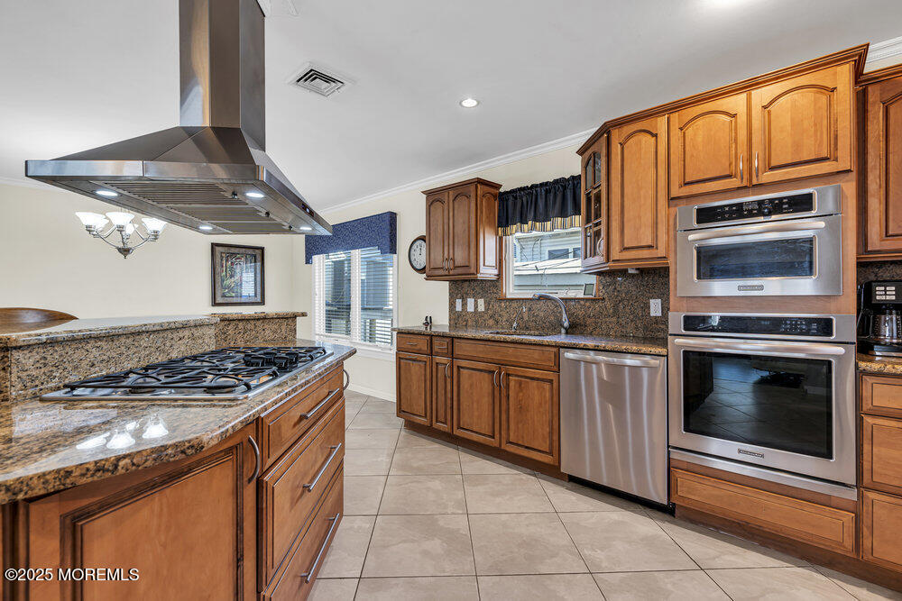 2 A Holiday Road Seaside Heights, NJ 08751 - Photo 20 of 50 a kitchen with stainless steel appliances granite countertop a stove top oven a sink and dishwasher