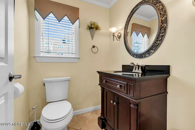 a bathroom with a toilet a sink and a mirror