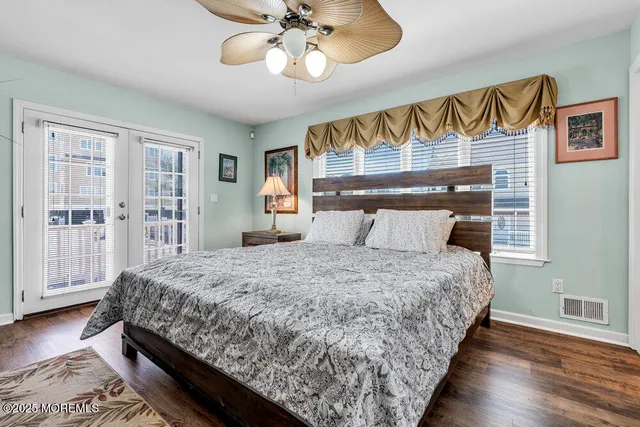 a bedroom with bed and wooden floor