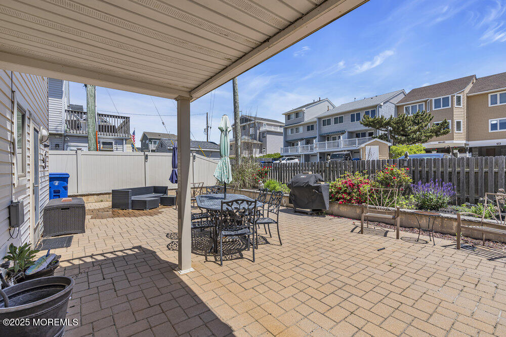 2 A Holiday Road Seaside Heights, NJ 08751 - Photo 32 of 50 a view of a patio with dining table and chairs with wooden fence