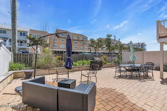 a view of a patio with couches and potted plants