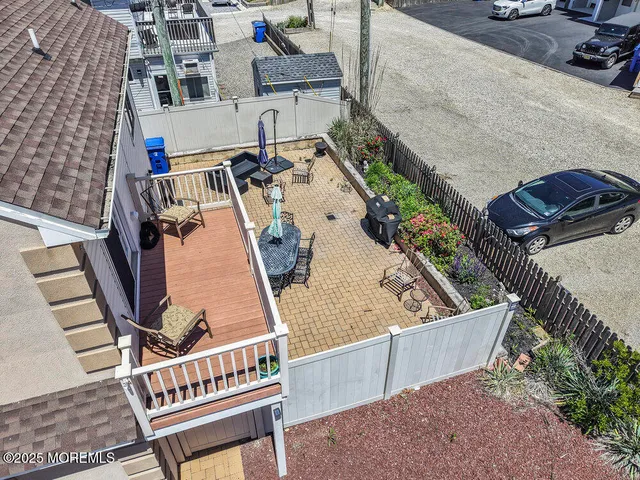 a roof deck with couches and wooden floor