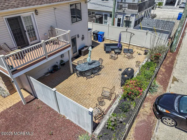 an aerial view of a house with garden space and sitting area