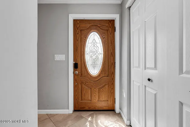 a view of a livingroom with wooden floor and a white door
