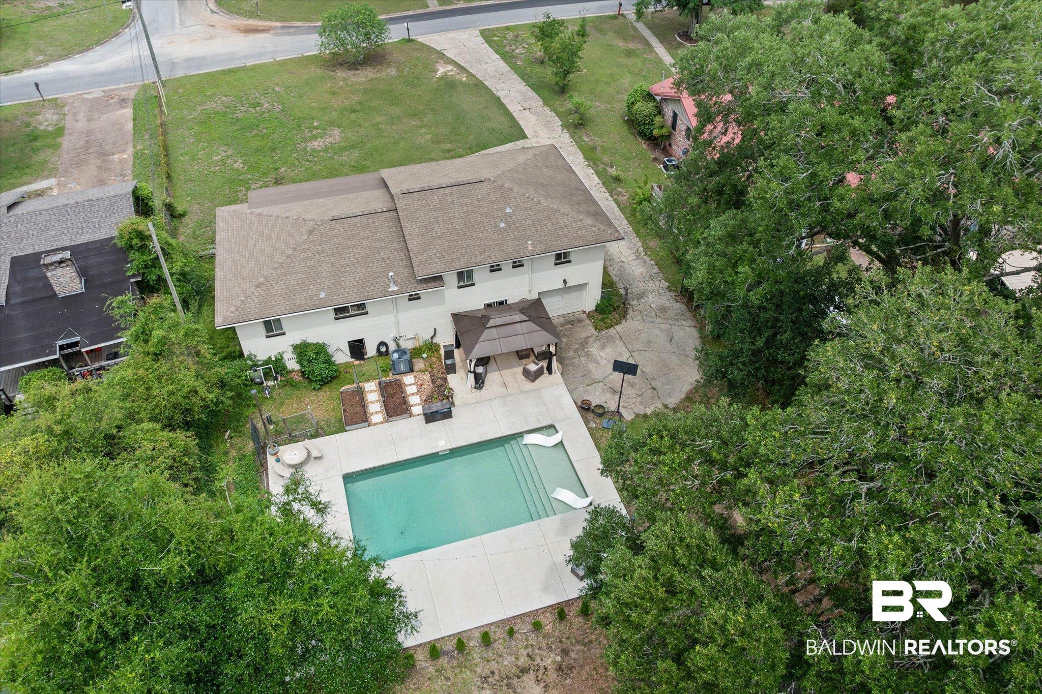 4213 Shan Drive East Mobile, AL 36693 - Photo 29 of 35 Expansive backyard featuring a rectangular swimming pool, a covered gazebo, and a concrete patio surround