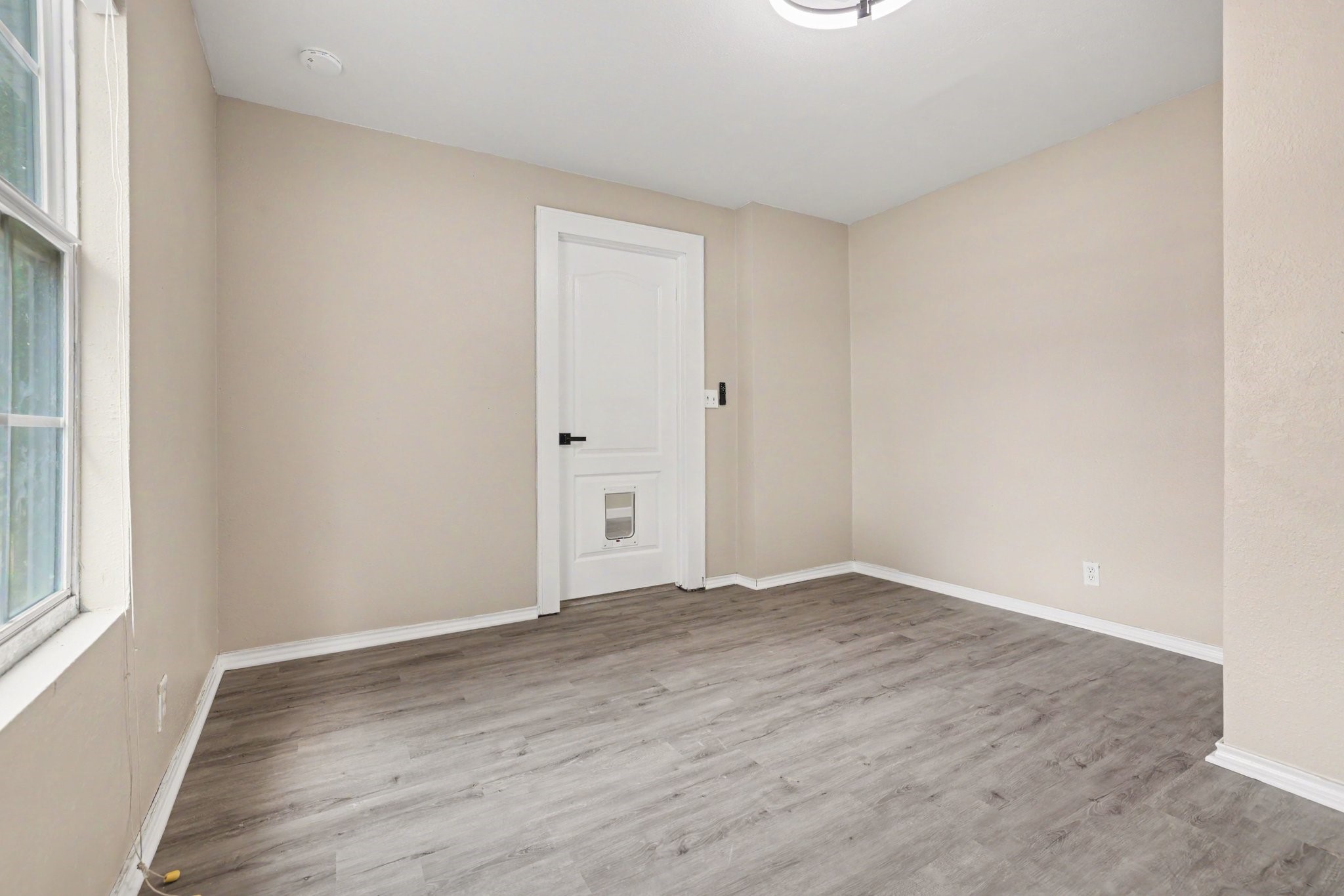 31730 Waller Tomball Road Waller, TX 77484 - Photo 37 of 50 This bedroom features classic white door with a pet door insert, making it pet-friendly.