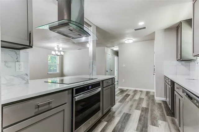 a kitchen with stainless steel appliances granite countertop a sink and stove top oven