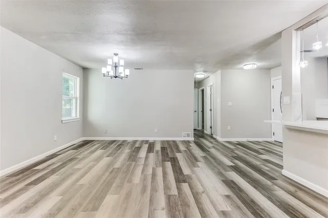 wooden floor in an empty room with a fireplace