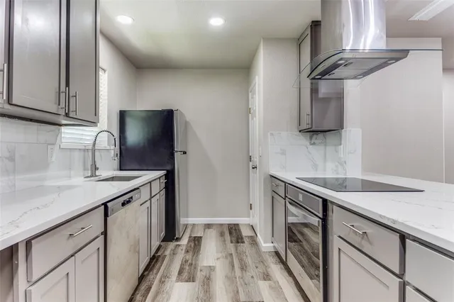 a kitchen with stainless steel appliances granite countertop a sink stove and refrigerator