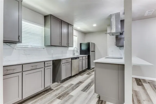 a kitchen with stainless steel appliances sink refrigerator and microwave