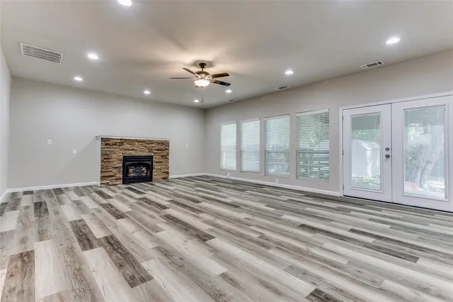 a view of empty room with fireplace and fan