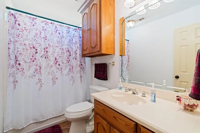 a bathroom with a sink toilet and mirror