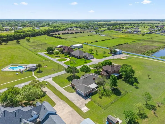 aerial view of a house with a yard