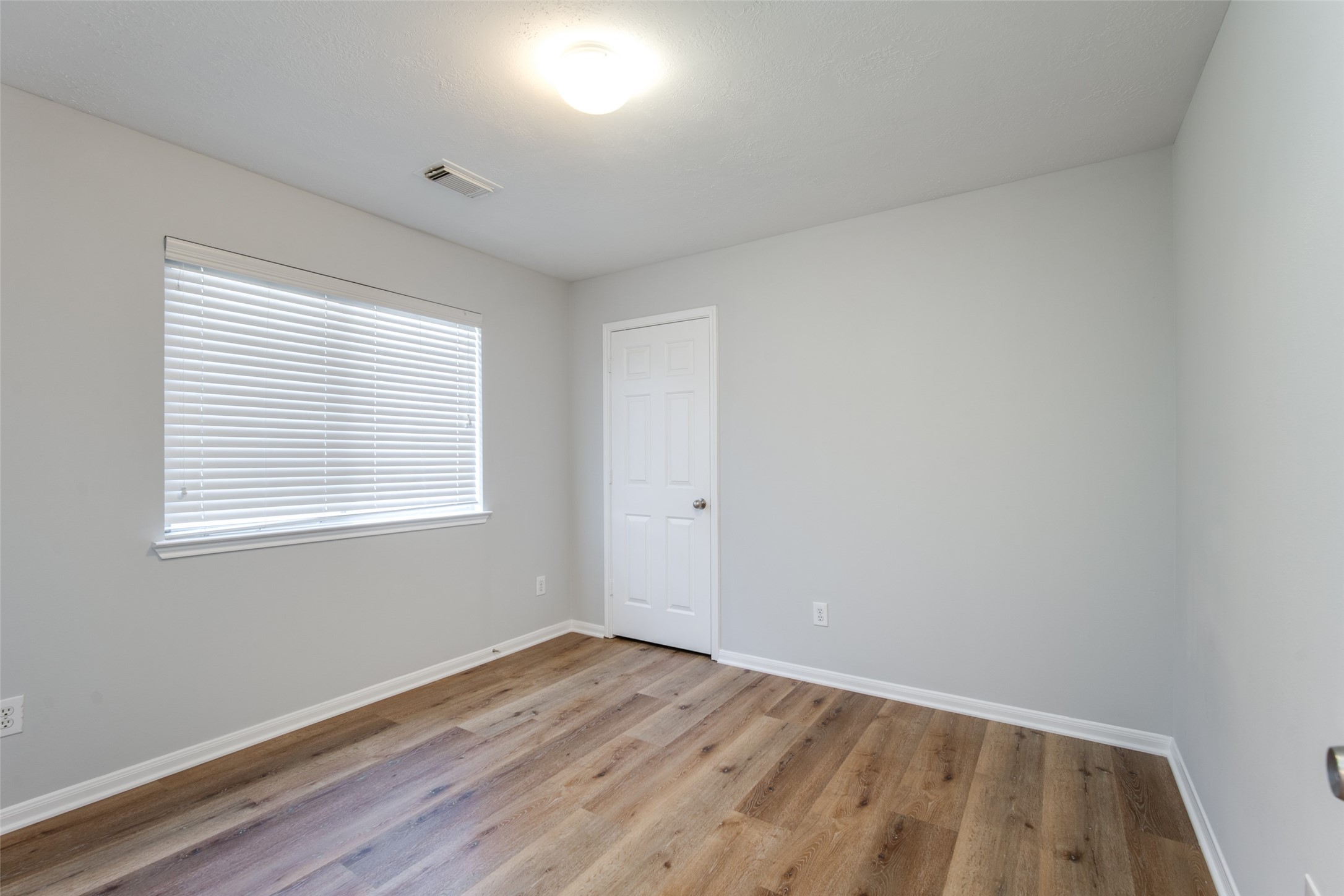 14510 Windmill Meadows Court Houston, TX 77082 - Photo 33 of 39 an empty room with wooden floor and windows