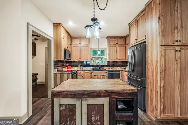 a view of a dining room with furniture large windows and wooden floor